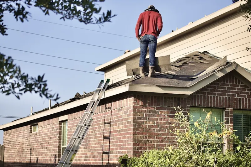 Professional roofer working on a residential roof in Reed Crossing